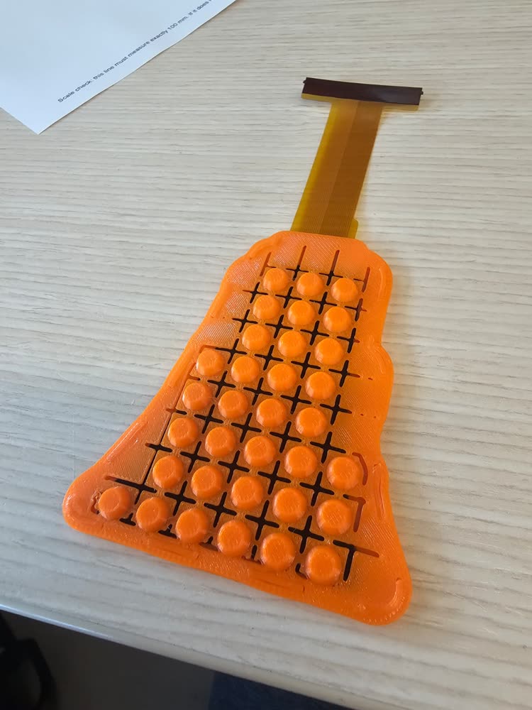 The assembled sensor in its printed TPU case, bump sheet on top.