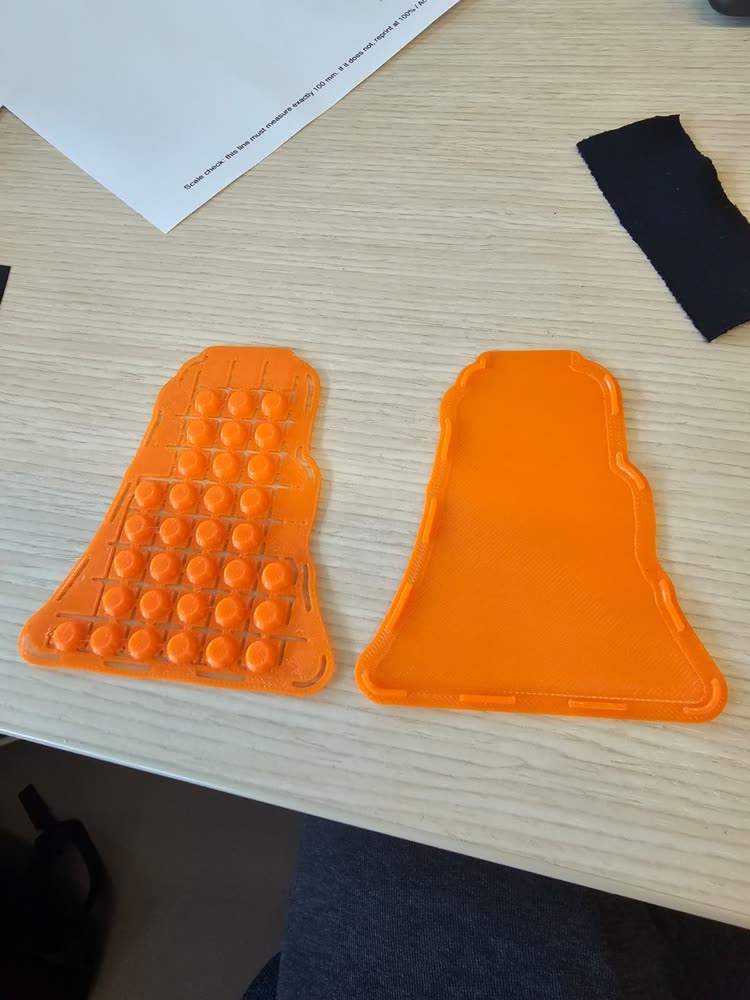 The two printed orange case parts side by side.