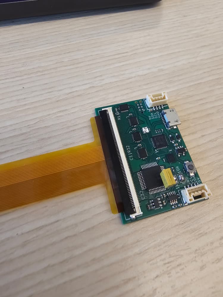 The stiffened tail fully inserted in the readout board's connector, latch closed.