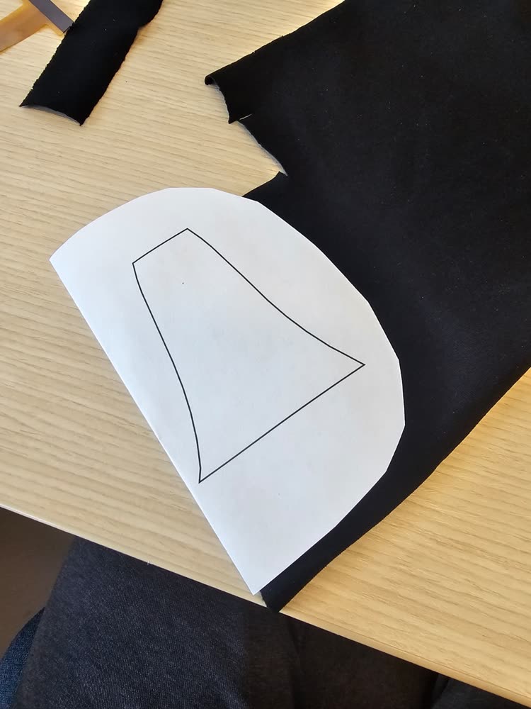 The folded template on the black piezoresistive fabric.