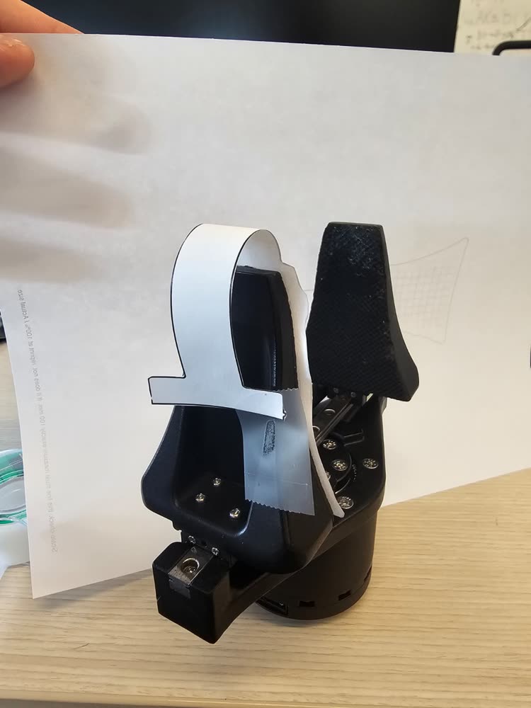 The paper tail wrapped around the jaw toward the readout board.